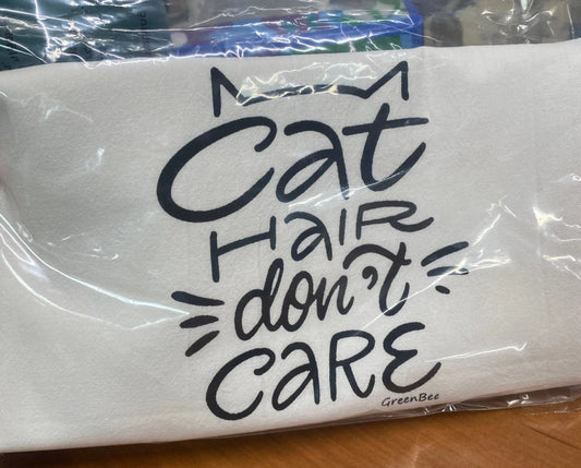 A white cotton kitchen towel with the phrase 'Cat Hair Don't Care' printed in black text at the top. The towel is displayed in packaging, indicating it may be a seconds sale item.