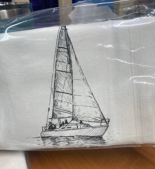 A white cotton tea towel with a hand-drawn black ink illustration of a sailboat printed on it.